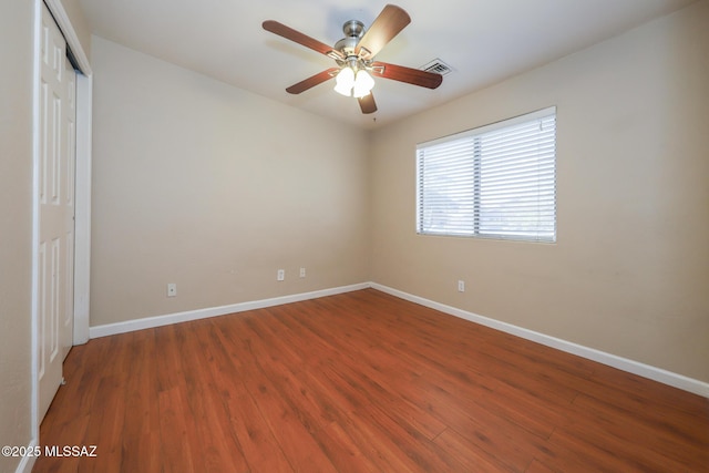 8418 N Sayante Way, Tucson, AZ 85743 - unfurnished bedroom featuring a closet, visible vents, baseboards, ceiling fan, and wood finished floors