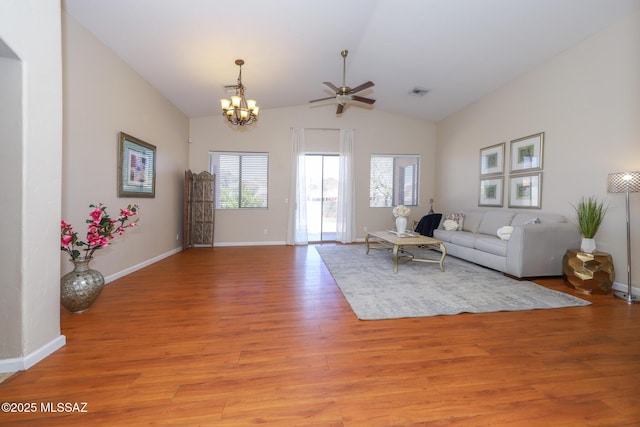 8418 N Sayante Way, Tucson, AZ 85743 - living room with visible vents, light wood-style flooring, baseboards, ceiling fan with notable chandelier, and vaulted ceiling