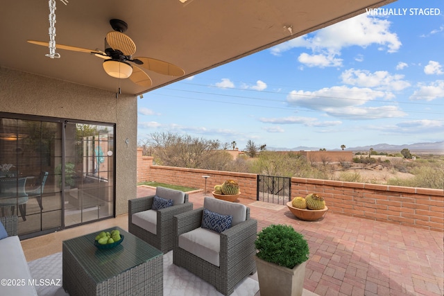 view of patio featuring fence, an outdoor living space, and a ceiling fan