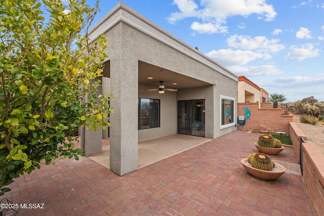 back of property featuring fence, a patio area, stucco siding, and a ceiling fan