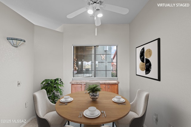 dining space with a ceiling fan