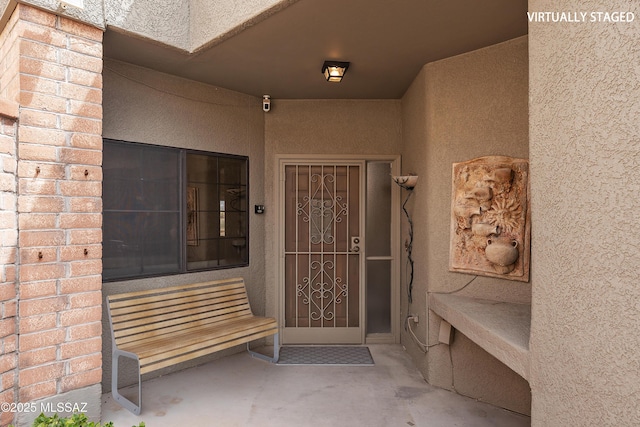 view of exterior entry with stucco siding