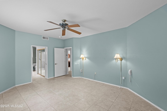 spare room with visible vents, ceiling fan, baseboards, and tile patterned floors