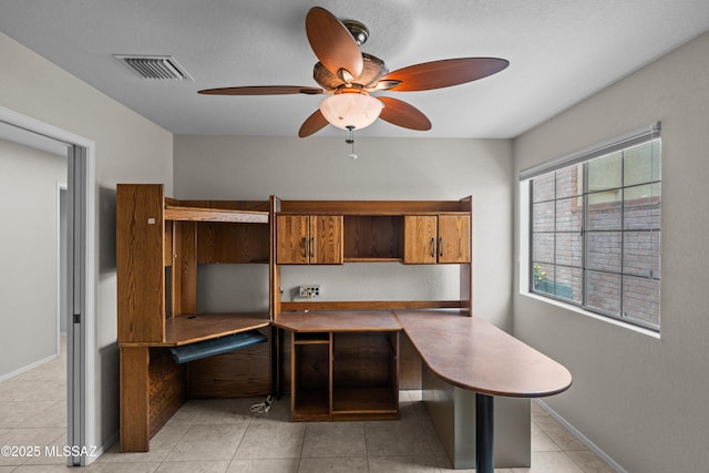 office area featuring visible vents, ceiling fan, light tile patterned flooring, and baseboards