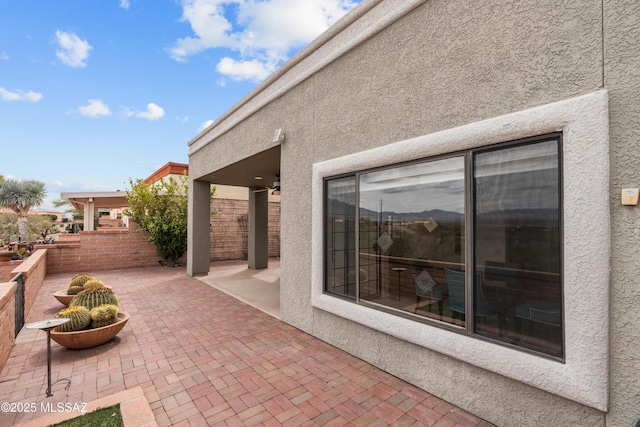 view of patio / terrace featuring fence and a ceiling fan