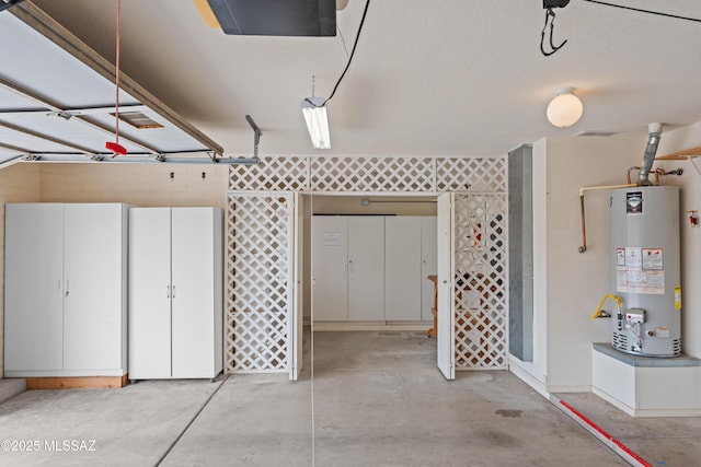 garage with a garage door opener and water heater