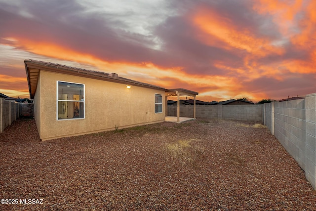 9379 E Grapevine Spring Pl, Tucson, AZ 85710 - rear view of property with a fenced backyard and stucco siding