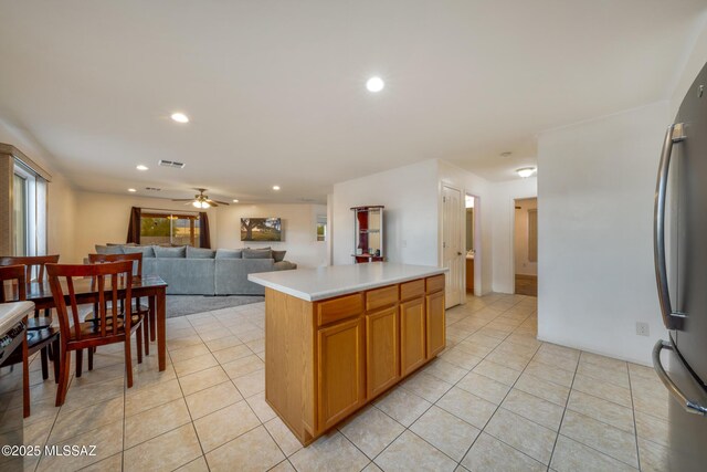 9379 E Grapevine Spring Pl, Tucson, AZ 85710 - kitchen featuring light tile patterned flooring, light countertops, freestanding refrigerator, recessed lighting, and a ceiling fan