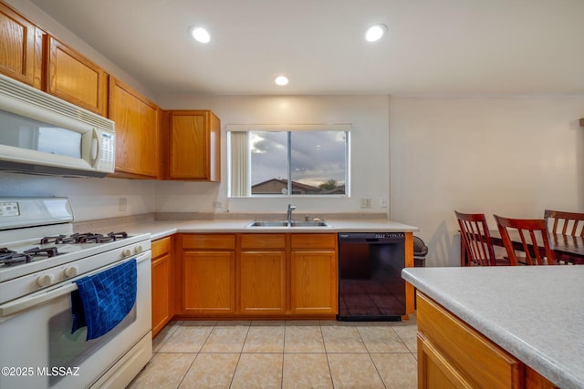 9379 E Grapevine Spring Pl, Tucson, AZ 85710 - kitchen with white appliances, light tile patterned flooring, light countertops, recessed lighting, and brown cabinets