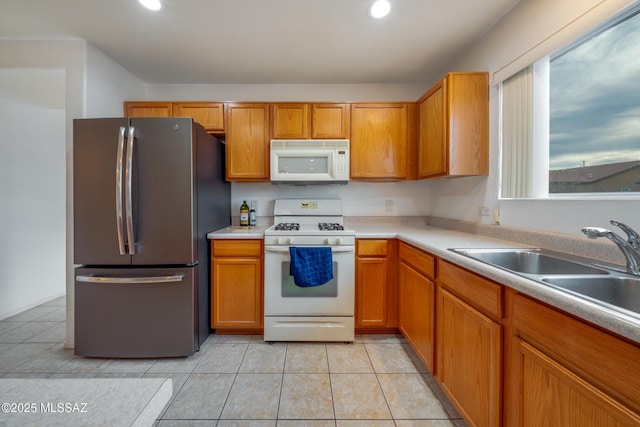9379 E Grapevine Spring Pl, Tucson, AZ 85710 - kitchen with white appliances, recessed lighting, light countertops, and brown cabinets