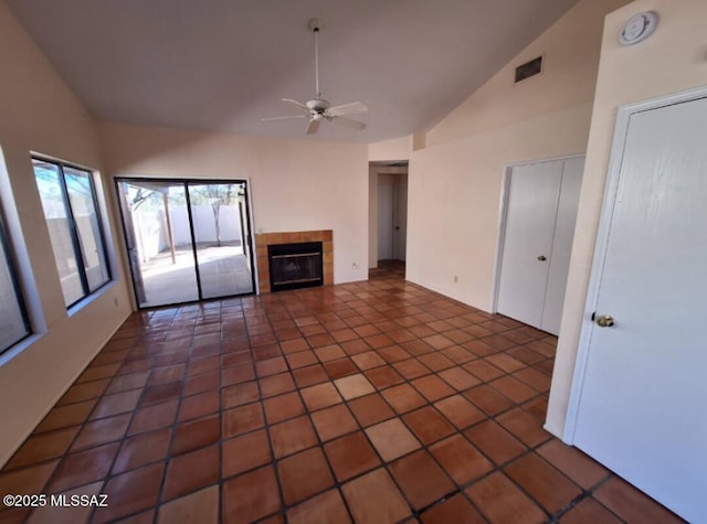 unfurnished living room featuring high vaulted ceiling, a ceiling fan, a fireplace, tile patterned flooring, and visible vents