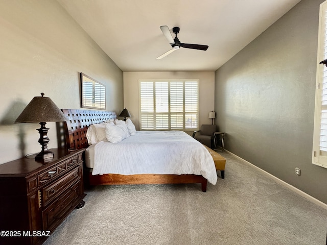 carpeted bedroom featuring baseboards, vaulted ceiling, and ceiling fan