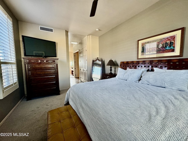 bedroom with carpet flooring, ceiling fan, visible vents, and multiple windows