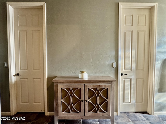 bathroom with baseboards and a textured wall