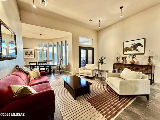 living room with baseboards, a high ceiling, and visible vents