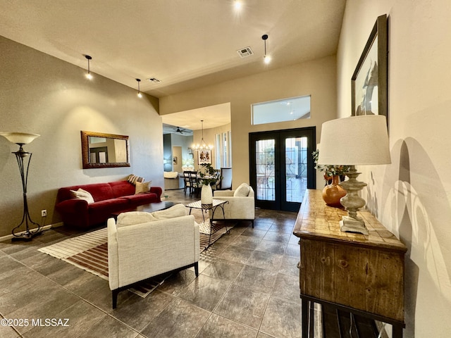 living area featuring baseboards, visible vents, french doors, and a notable chandelier