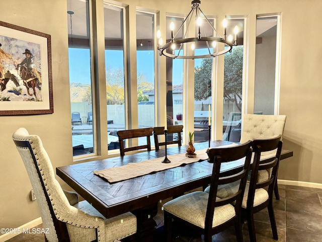 dining space with plenty of natural light, baseboards, and a chandelier