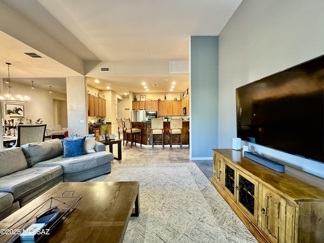 living room with baseboards, visible vents, recessed lighting, and an inviting chandelier