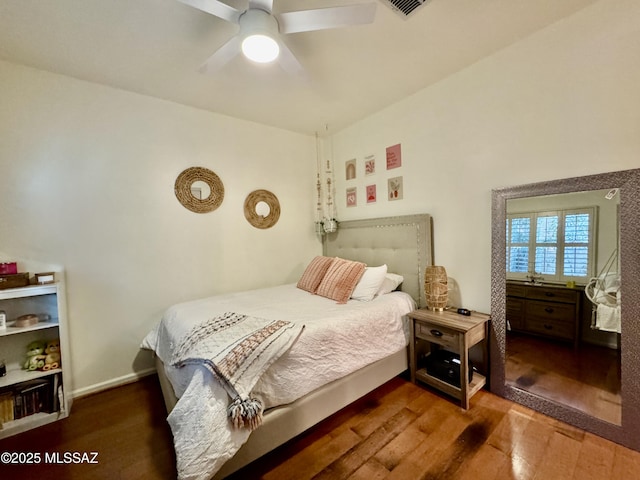 bedroom featuring baseboards, ceiling fan, and wood finished floors