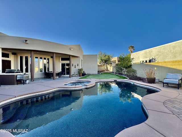 view of pool featuring a fenced backyard, a fenced in pool, an in ground hot tub, and a patio area
