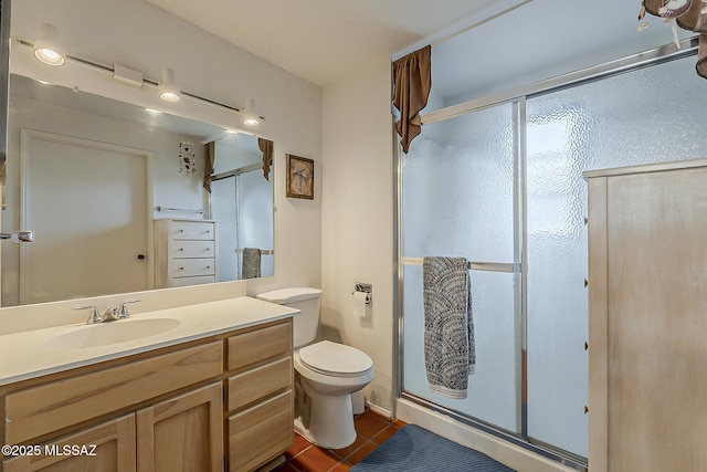 full bath with tile patterned floors, a stall shower, toilet, and vanity