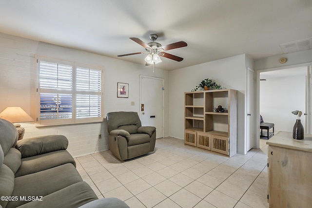living area featuring light tile patterned floors, visible vents, and a ceiling fan