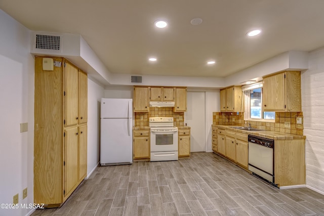285 E Los Rincones, Green Valley, AZ 85614 - kitchen with white appliances, light wood-type flooring, under cabinet range hood, tasteful backsplash, and tile counters