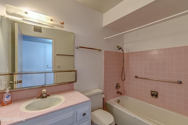 full bath with visible vents, toilet, vanity, and shower / bathtub combination