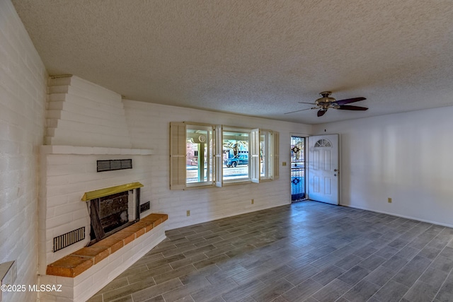 285 E Los Rincones, Green Valley, AZ 85614 - unfurnished living room featuring a textured ceiling, ceiling fan, a fireplace, dark wood-style flooring, and baseboards