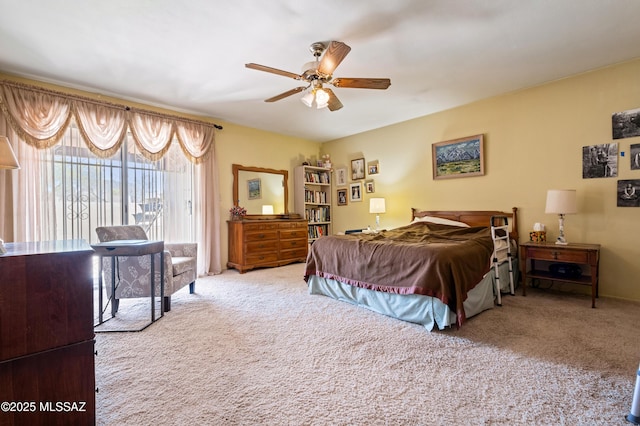 carpeted bedroom with ceiling fan and access to exterior