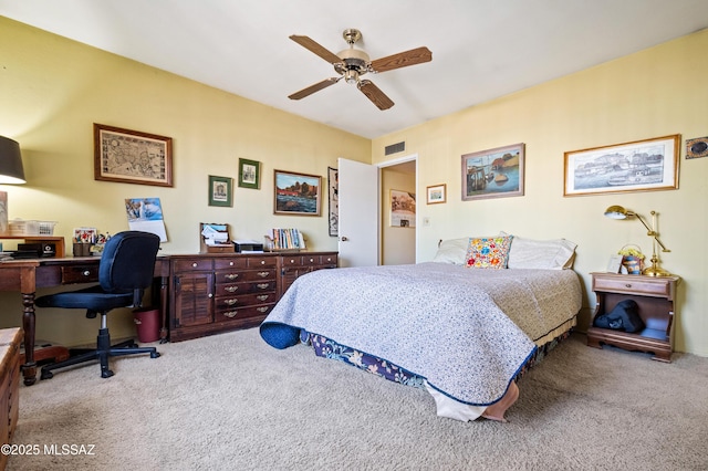carpeted bedroom featuring visible vents and a ceiling fan