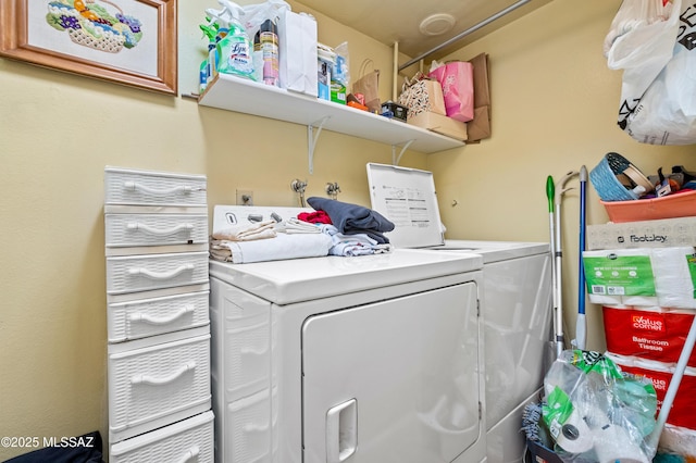 clothes washing area with washing machine and dryer and laundry area