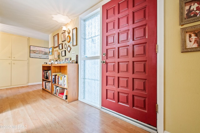 entryway with baseboards and wood finished floors