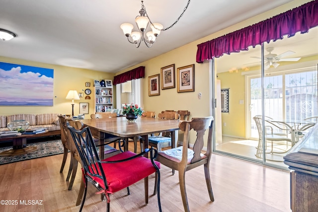 dining area featuring wood finished floors, baseboards, and a chandelier