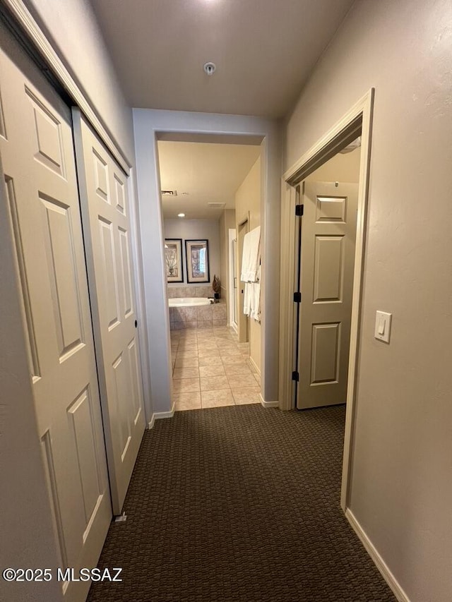 5775 S Camino Del Sol Unit 6104, Green Valley, AZ 85622 - hall with light carpet, baseboards, and light tile patterned floors
