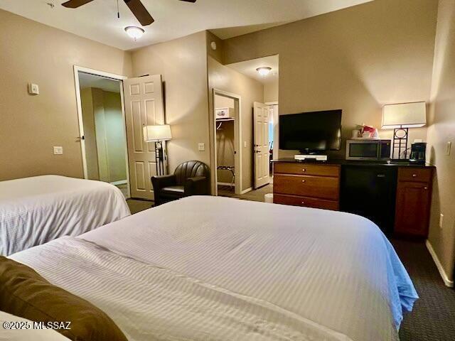 5775 S Camino Del Sol Unit 6104, Green Valley, AZ 85622 - bedroom with baseboards, dark carpet, and a ceiling fan