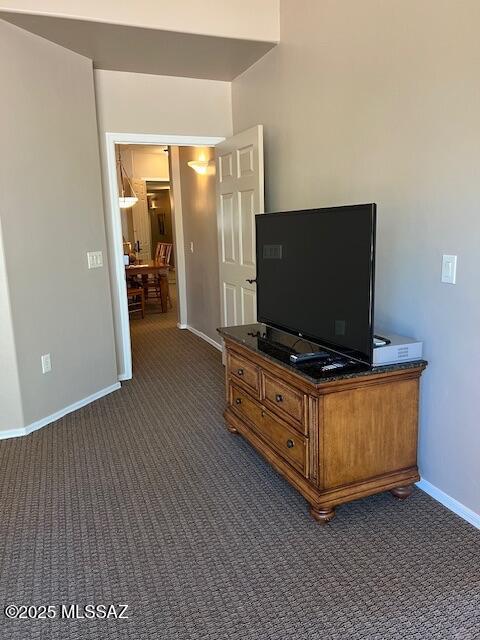 5775 S Camino Del Sol Unit 6104, Green Valley, AZ 85622 - living area featuring dark colored carpet and baseboards