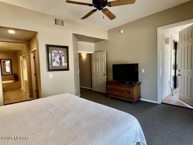 5775 S Camino Del Sol Unit 6104, Green Valley, AZ 85622 - bedroom featuring dark colored carpet, a ceiling fan, ensuite bathroom, and baseboards