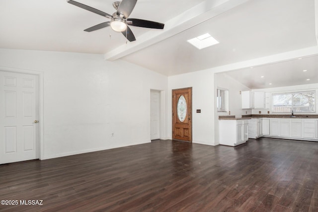 6806 S 4th Ave, Tucson, AZ 85756 - unfurnished living room featuring dark wood-type flooring, a ceiling fan, and baseboards