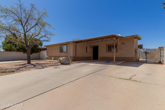 6806 S 4th Ave, Tucson, AZ 85756 - single story home with a gate, concrete driveway, stucco siding, fence, and a carport