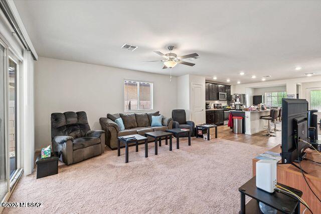 34932 S Iron Jaw Dr, Red Rock, AZ 85145 - living room with recessed lighting, visible vents, light colored carpet, and ceiling fan
