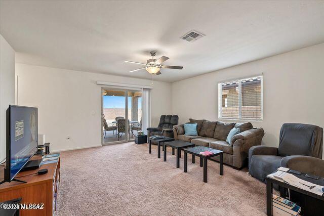34932 S Iron Jaw Dr, Red Rock, AZ 85145 - living area featuring ceiling fan, baseboards, visible vents, and light carpet