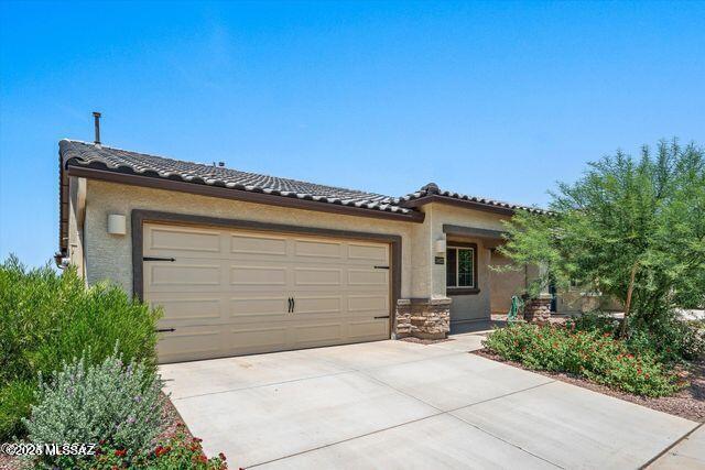 34932 S Iron Jaw Dr, Red Rock, AZ 85145 - view of front of property with stucco siding, a tiled roof, an attached garage, and driveway