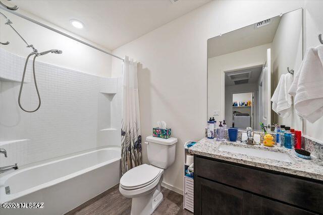 34932 S Iron Jaw Dr, Red Rock, AZ 85145 - bathroom with vanity, toilet, wood finished floors, and shower / tub combo