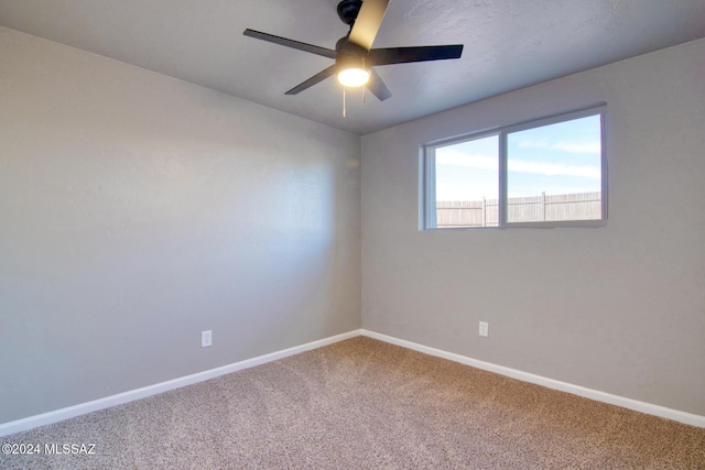 unfurnished room featuring baseboards, ceiling fan, and carpet floors