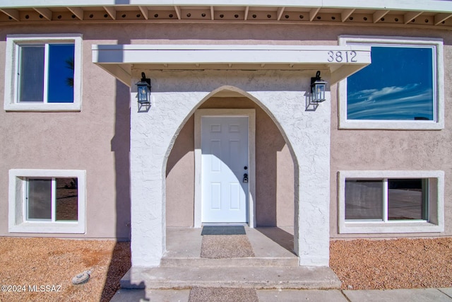 property entrance featuring stucco siding