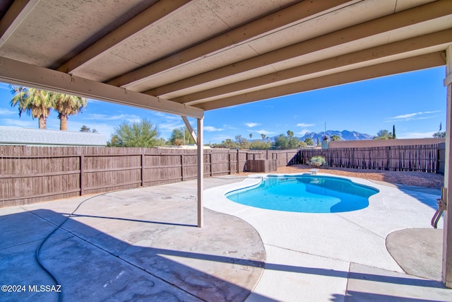 view of swimming pool featuring a patio, a fenced in pool, and a fenced backyard