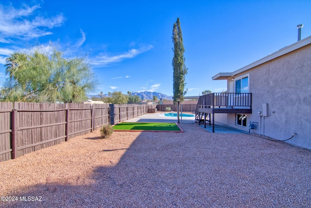 view of yard with a fenced backyard, a patio, a mountain view, and a fenced in pool