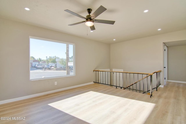 spare room featuring recessed lighting, baseboards, ceiling fan, and wood finished floors