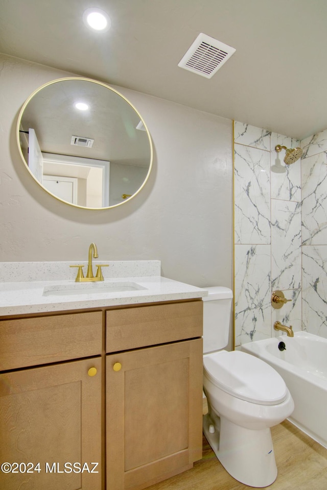 bathroom featuring visible vents, toilet, vanity, and shower / tub combination